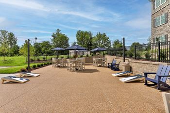 Community patio with grills, chairs and umbrellas